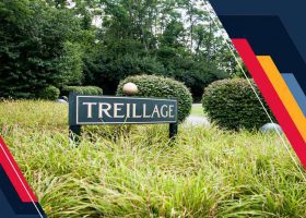 A sign that says trelliage in front of bushes and trees.