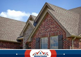 A house with a shingled roof, showcasing the craftsmanship of a roofing company in Dayton, OH.