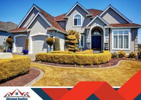 An image of a house with bushes in front of it.