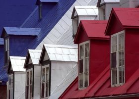 A row of houses with **metal** roofs.