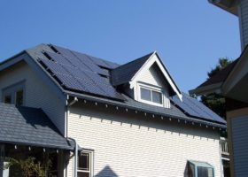 A house with solar panels on the roof undergoing spring cleaning.