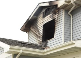 A house with a rooftop fire poses a significant risk of fire damage.