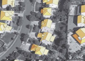 An aerial view of houses with yellow roofs.