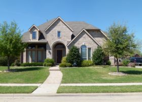 A home in the suburbs of Texas with a large yard, ready for summers.