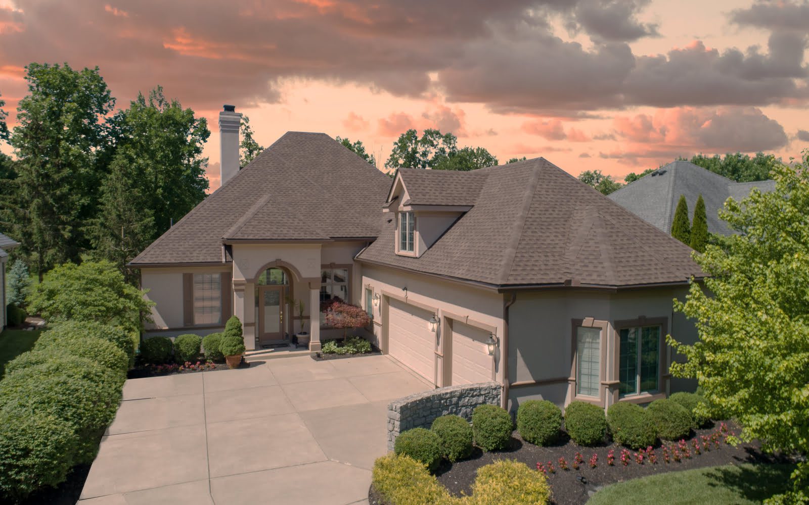 An aerial view of a home at sunset.