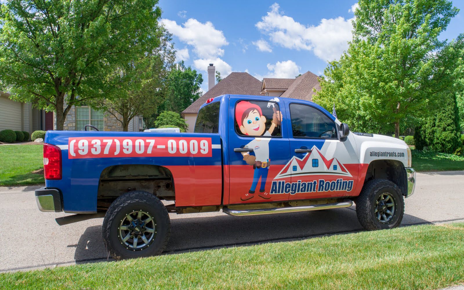 A truck is parked in front of a house.