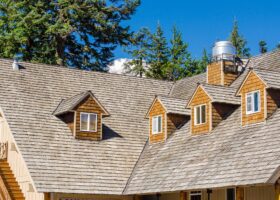 A house with a shingled roof and ventilation.